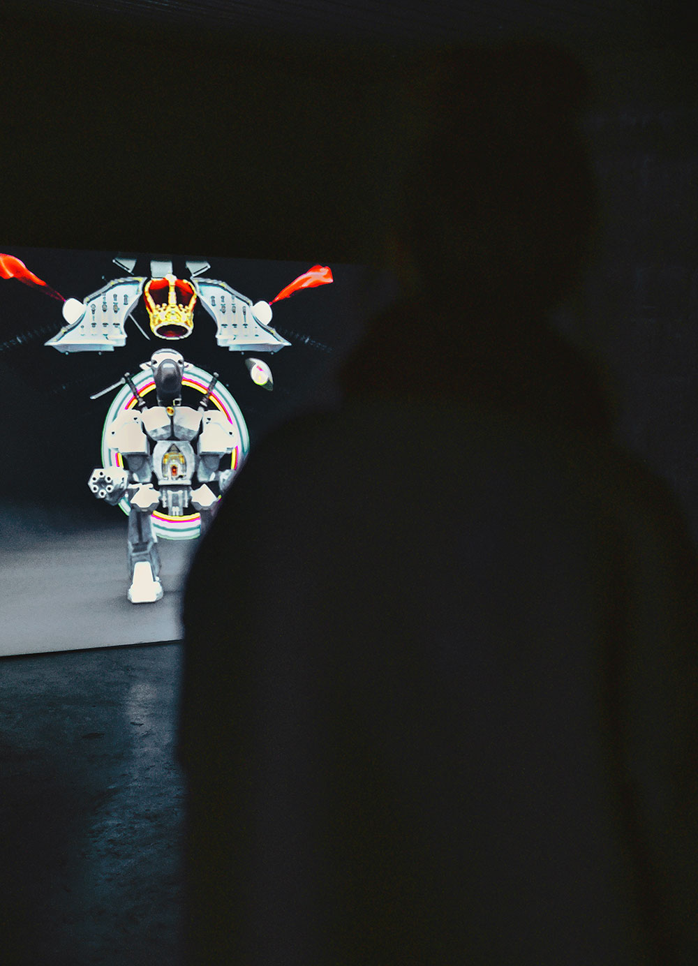 photo of colorful contemporary video art installation with woman standing and watching