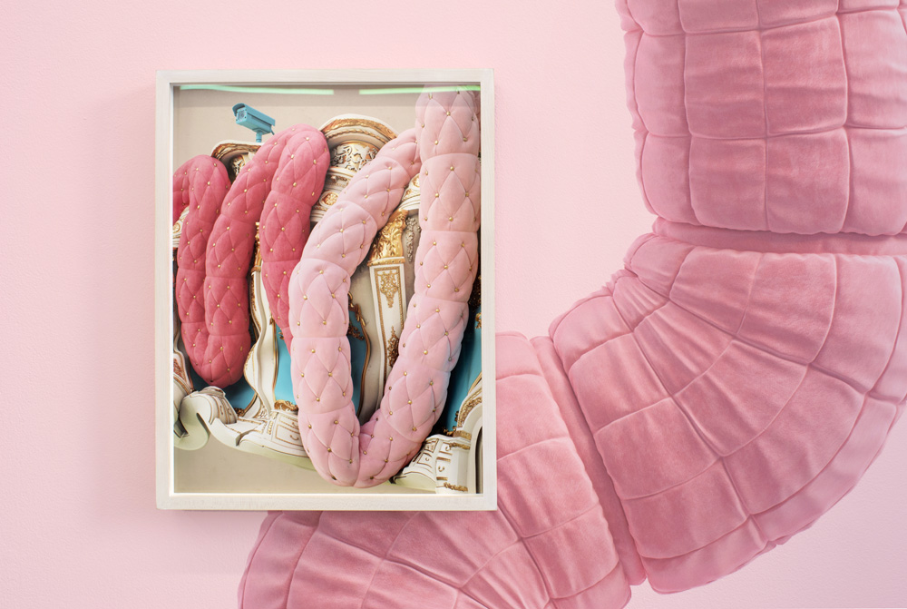 Wall decal by Monaghan with electronic devices juxtaposed near colorful soft fabrics.