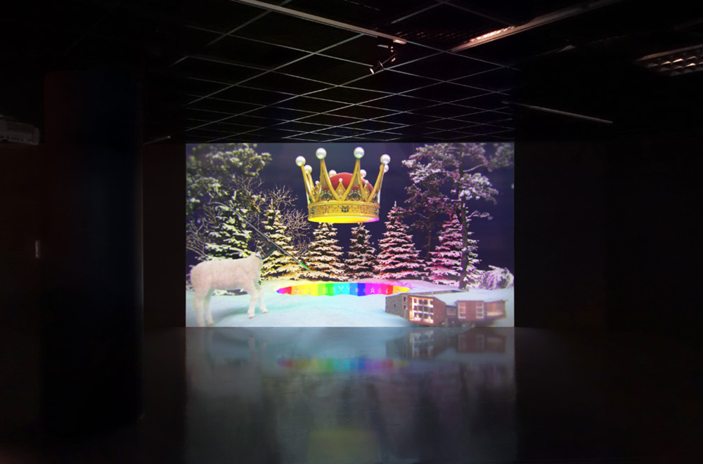 video installation in gallery showing still from Monaghan's video installation showing snow and night sky.